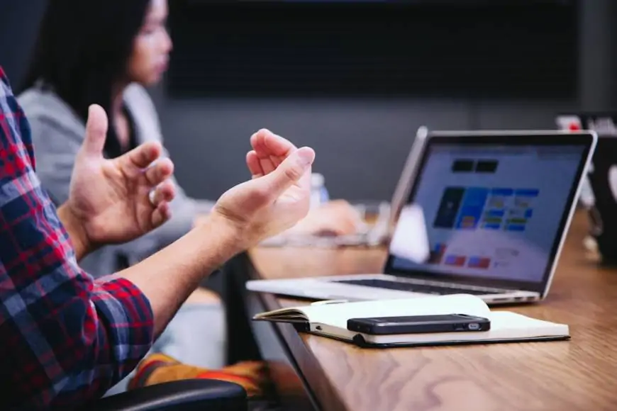 A team in an office discussing sales acceleration strategies during a meeting